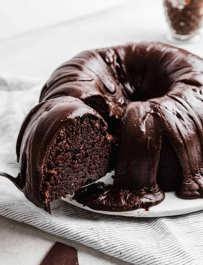 Boo's Choco Charm chocolate Bundt with glossy chocolate glaze, a slice lifted out